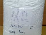 a bag of white pillows sitting on top of a cardboard box
