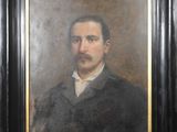 portrait of a man with a mustache in a black frame
