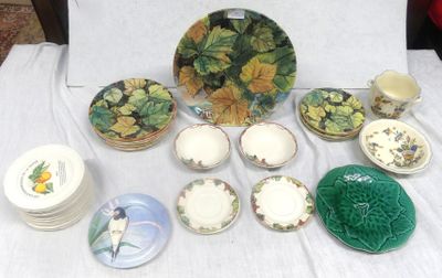 many plates and bowls on a table with a white table cloth