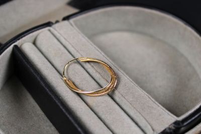 a gold ring sitting in a case on a table