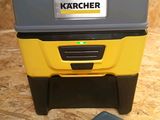 a close up of a yellow and black cooler sitting on top of a wooden floor