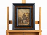 tableau posé sur un chevalet, avec en arrière-plan une peinture représentant une scène de village