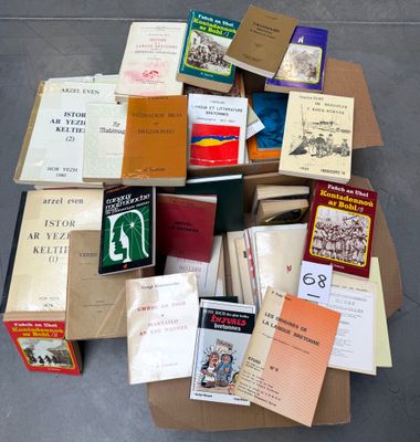 many books in a cardboard box on the floor