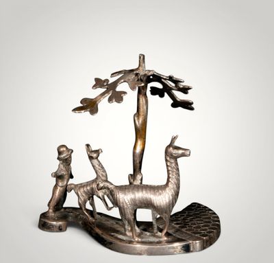 an image of a statue of a man and two llamas in a tree