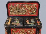 a black and red chest with gold decorations on it