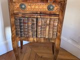 a small wooden table with books on top of it