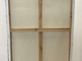 an easel with a window on top of it in a room