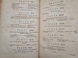 an old book with a page of text on it sitting on top of a table