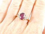 an image of a woman ' s hand with a diamond and ruby ring