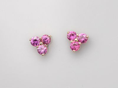 a pair of pink cubicge earrings on a white background