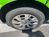 a close up of a tire on a green car