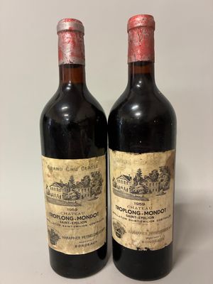 two bottles of wine sitting next to each other on a table