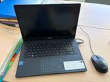 a laptop computer sitting on a desk next to a mouse