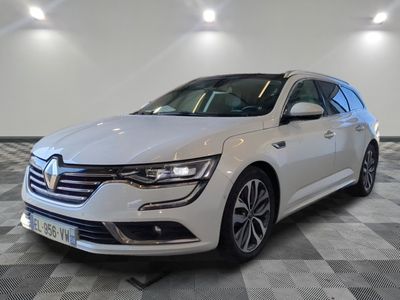the white car is parked on a checkered floor in a room