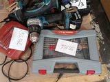 a pile of power tools on a pallet in a room