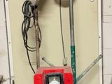 a red machine that is sitting in a garage