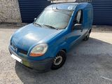 a blue van parked in front of a building with a roof rack
