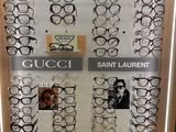 many pairs of glasses on display in a display case