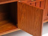 a wooden cabinet with a door open on a white floor