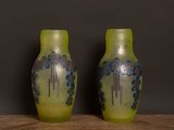 two vases that are sitting on a table