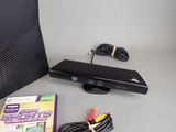 a video game system sitting on a table next to a game controller