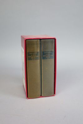 two books in a red box on a white surface