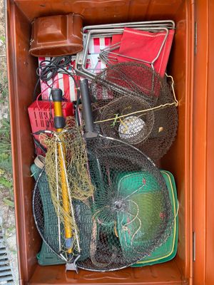 a brown box filled with fishing gear and other items