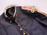 an old military coat with buttons and a belt on a white background