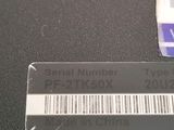 a picture of a serial number label on a computer keyboard