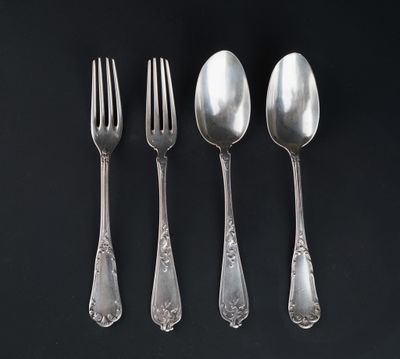 four silver spoons and a fork on a black surface