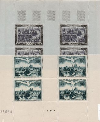 two stamps with a picture of a city on them on a sheet of paper