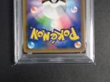 a close up of a pokemon trading card in a plastic case