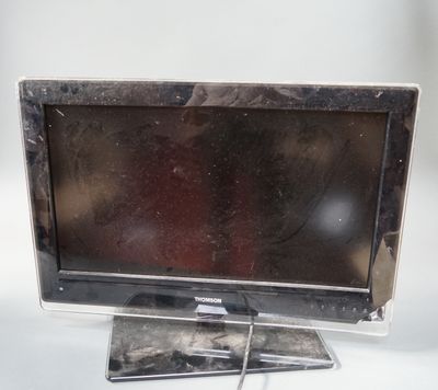 a small television sitting on a stand on a white surface