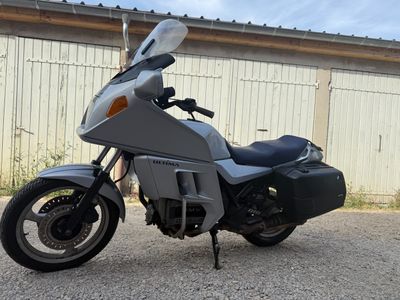 a silver motorcycle parked in front of a building