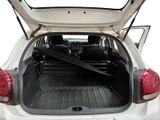 the back of a white car with its trunk open showing the cargo area