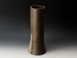 a brown vase that is sitting on a table