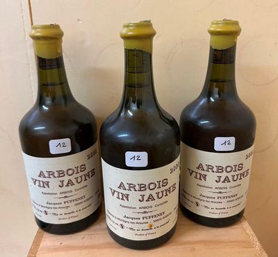 three bottles of wine sitting on top of a wooden box