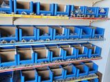 many blue bins on the shelves in the garage