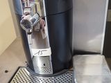 a coffee machine sitting on a counter next to a cup