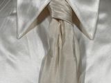 a white shirt and a white tie on a mannequin mannequin