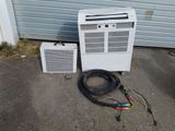 a white air conditioner sitting next to an air conditioner