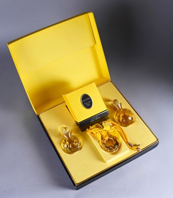 a yellow box with three bottles of perfume in it