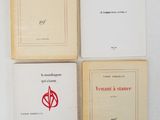 four books on a white surface with a red and black logo on them