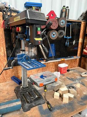 a workbench with a drillet and other tools on it
