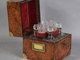 a small wooden box with glasses inside of it