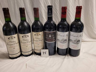 several bottles of wine are lined up on a table