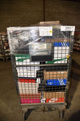 a metal cart with many boxes on it in a warehouse