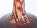 a glass vase with a red and white design on it