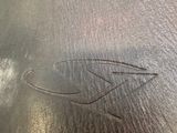 the inside of a brown leather bag with a bird on it