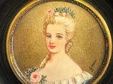 painting of a woman with flowers in her hair in a black frame